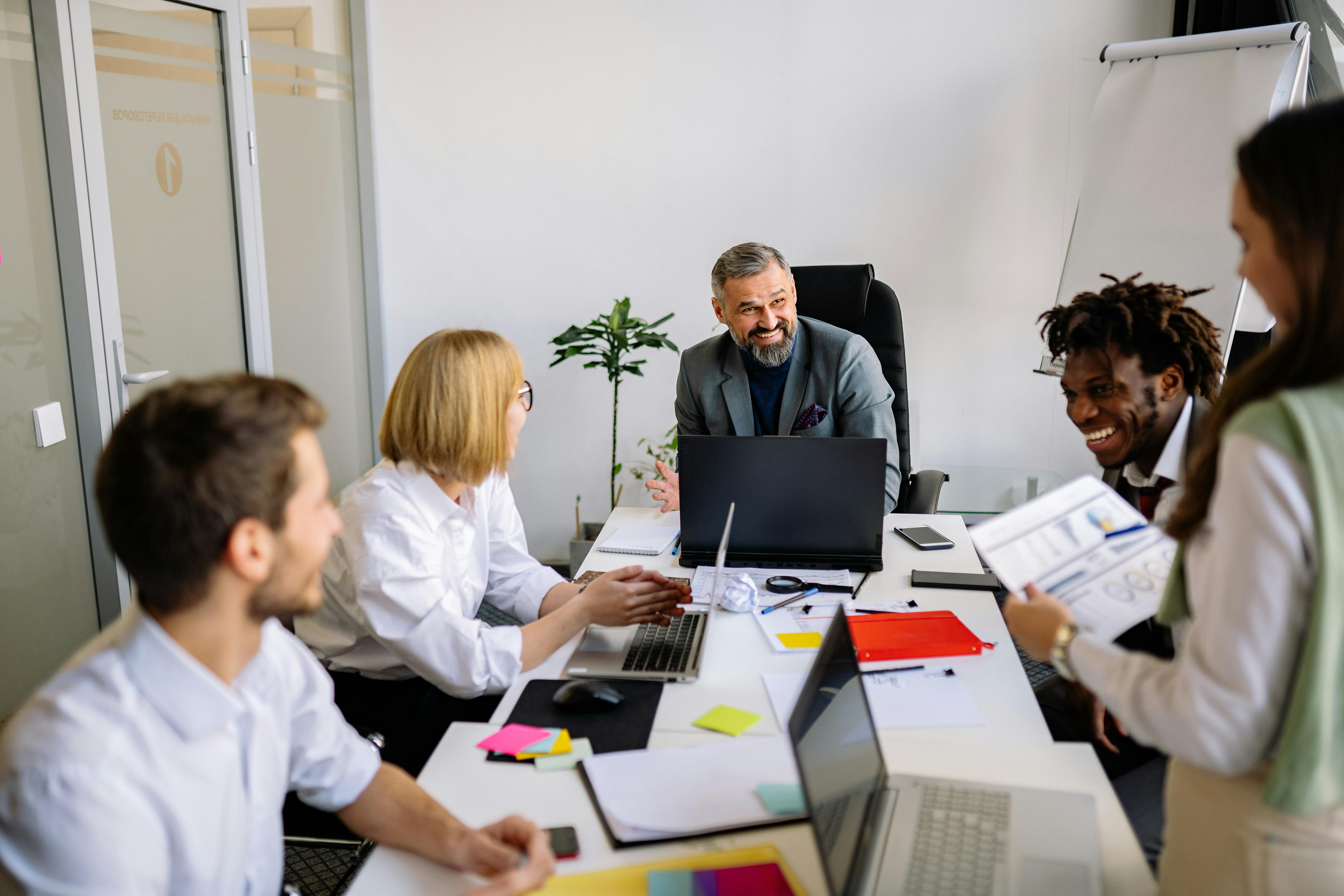 Leader speaking with a collaborative team in a modern office
